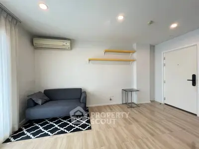 Modern living room with sleek sofa and stylish shelves in a bright, airy space.