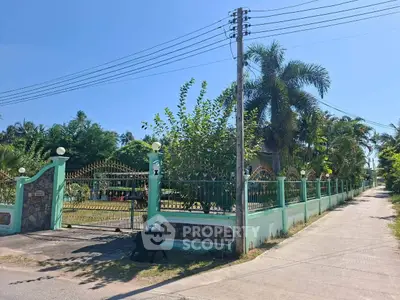 Charming gated property with lush garden and palm trees, perfect for serene living.