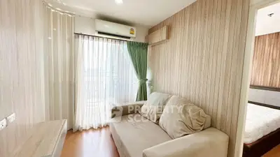 Cozy living room with natural light and modern decor in a stylish apartment.