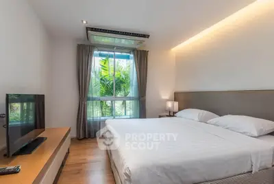 Modern bedroom with large window and stylish decor in a luxury apartment.