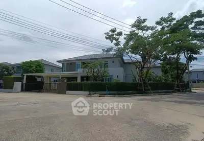 Spacious modern house with lush greenery and ample parking space