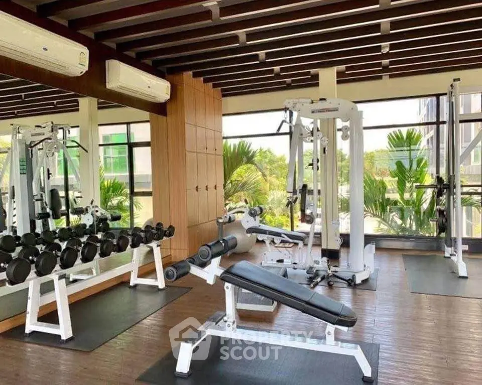 Modern gym with state-of-the-art equipment and scenic views, perfect for fitness enthusiasts.