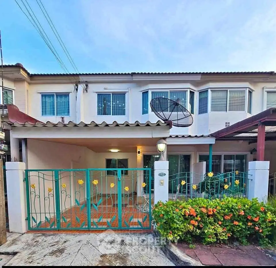 Charming townhouse with gated entrance and lush garden in a serene neighborhood.