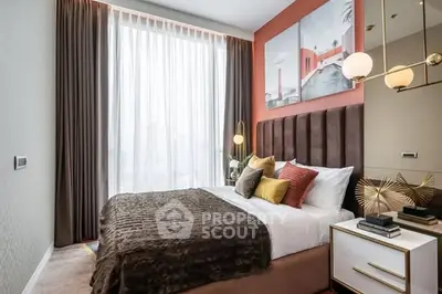 Luxurious bedroom with modern decor and large window offering natural light.
