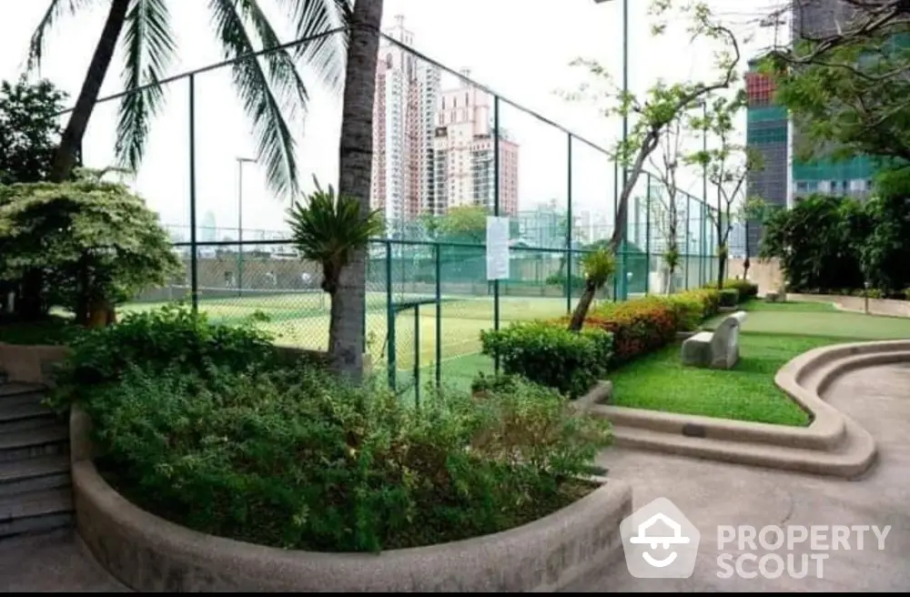 Luxurious urban garden with tennis court and skyline view, perfect for relaxation and recreation.