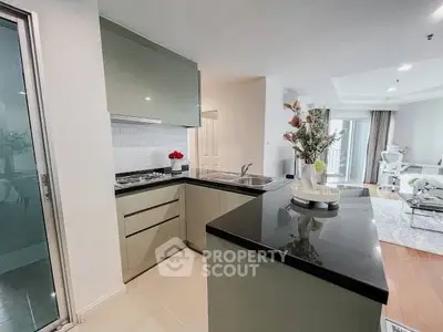 Modern open-layout kitchen with sleek cabinetry and spacious living area