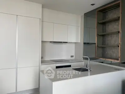 Modern kitchen with sleek white cabinetry and integrated appliances, featuring a minimalist design and open layout.