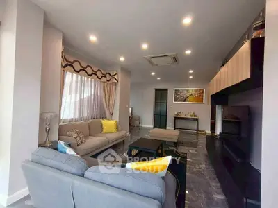 Spacious modern living room with stylish decor and ample natural light.