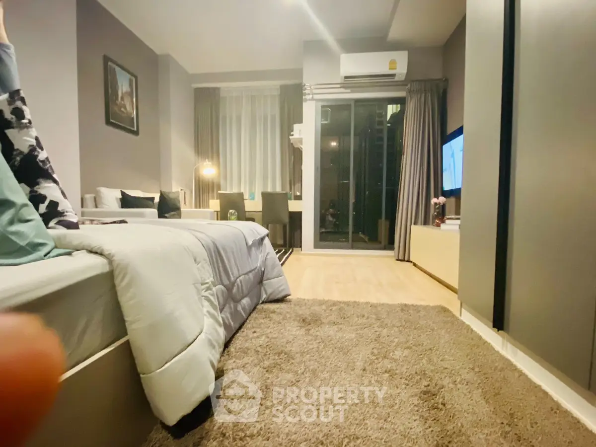 Cozy modern bedroom with balcony access and stylish decor