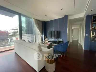 Luxurious modern living room with floor-to-ceiling windows and stunning city view.
