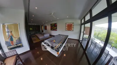 Luxurious living room with pool table and stunning balcony view