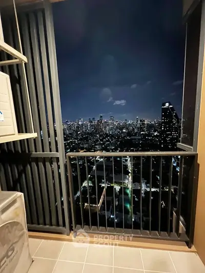 Stunning city skyline view from a high-rise balcony at night, perfect for urban living.