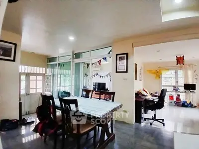 Spacious open-plan living and dining area with natural light and modern decor.