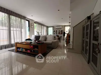 Spacious modern living room with large windows and elegant decor