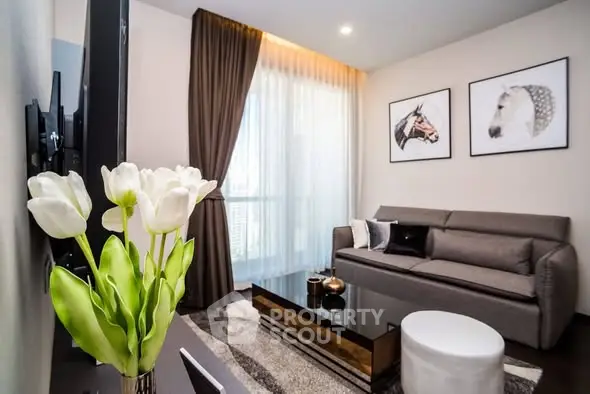 Stylish modern living room with elegant decor and large window view.