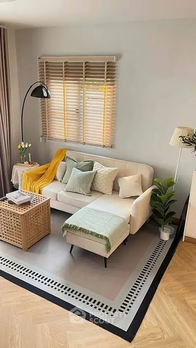 Charming living room with cozy sofa, stylish decor, and natural light, perfect for relaxation and entertaining.