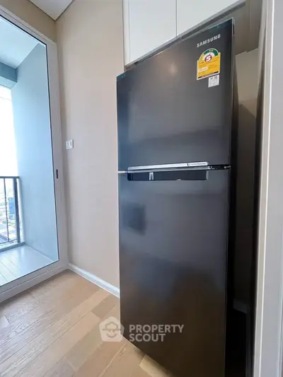 Modern kitchen with sleek Samsung refrigerator and balcony view