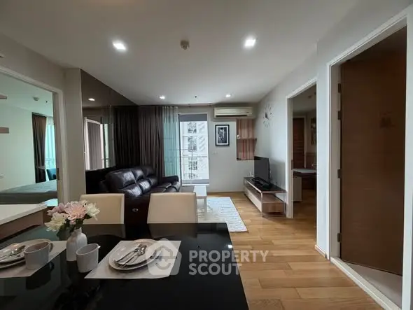 Modern living room with sleek furniture and open layout in a stylish apartment.