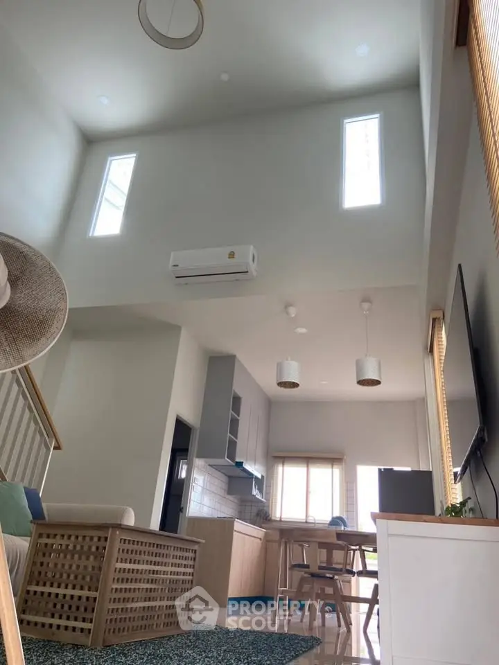 Spacious modern living room with high ceilings and open kitchen layout