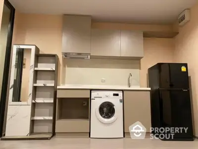 Modern kitchen with washing machine and fridge in compact layout