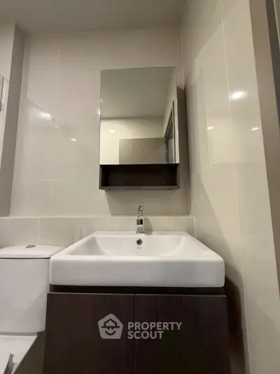Modern bathroom with sleek sink and mirror in stylish apartment