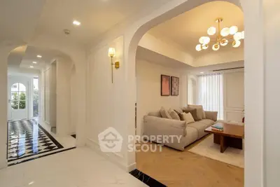 Elegant living room with modern chandelier and cozy seating area