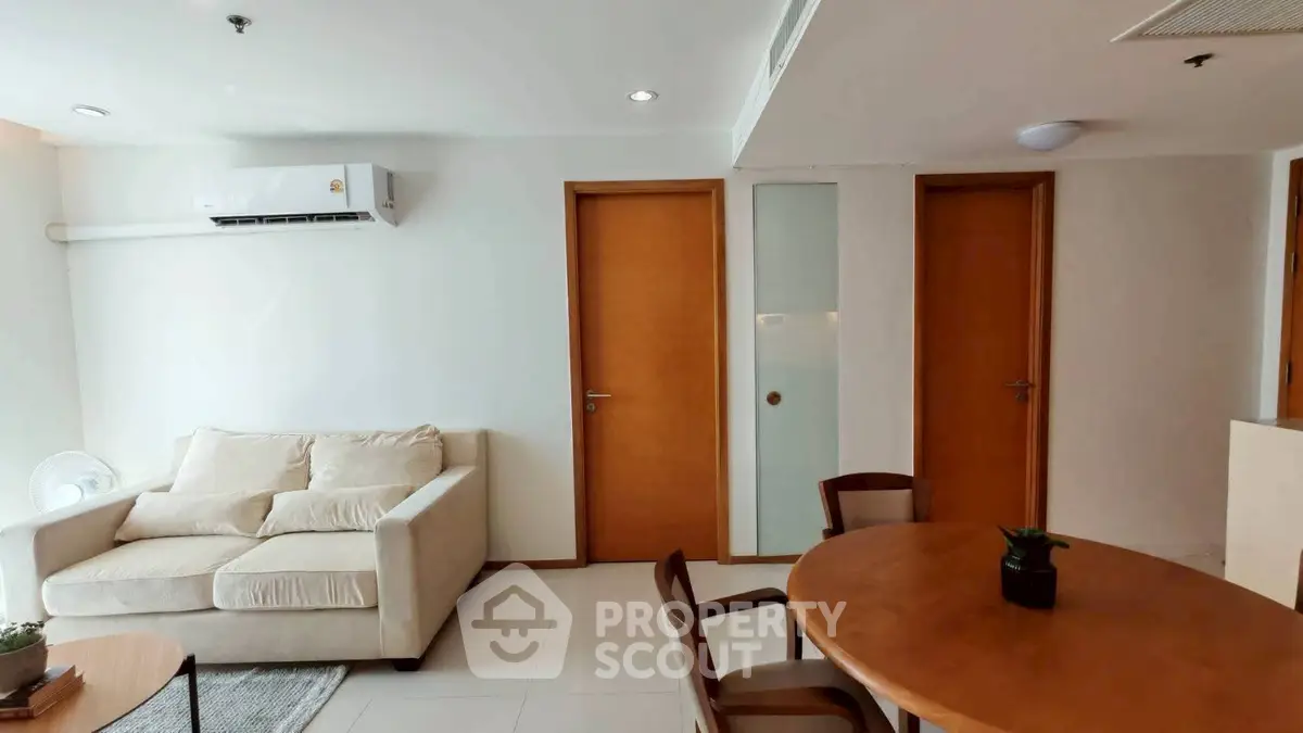 Modern living room with cozy sofa and dining area in a stylish apartment.