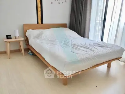 Modern bedroom with minimalist wooden bed and natural light
