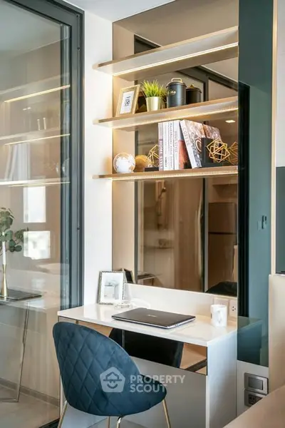 Modern study area with sleek desk and stylish shelving in contemporary apartment.