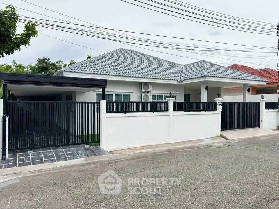 Modern single-story house with gated entrance and tiled roof