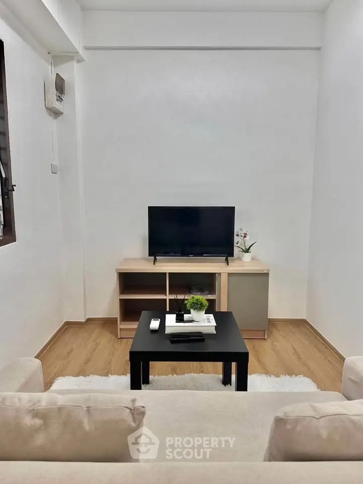 Cozy minimalist living room with TV and modern furniture