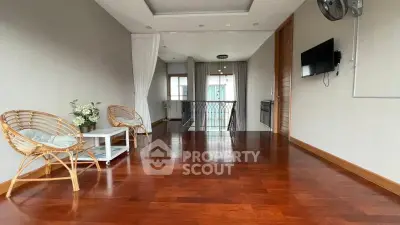 Spacious living area with wooden flooring and modern decor