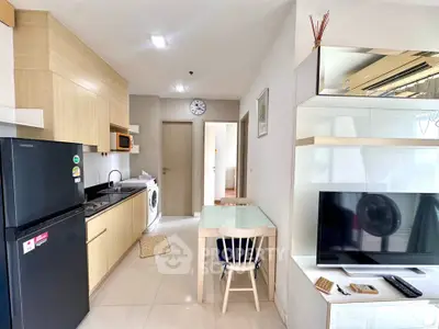 Modern kitchen and living area with sleek appliances and stylish decor