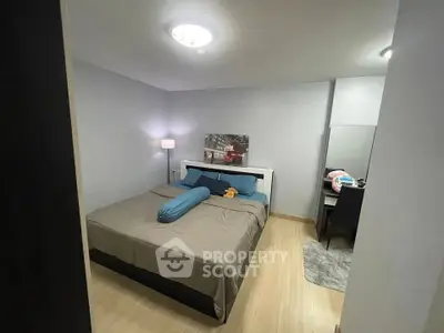 Cozy bedroom with modern decor and comfortable bed in stylish apartment.