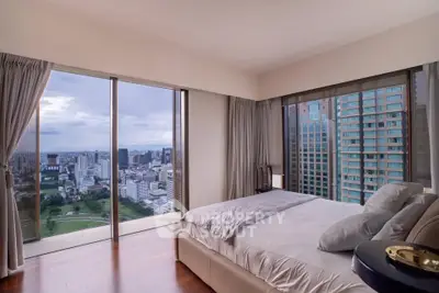 Luxurious bedroom with panoramic city view in high-rise apartment