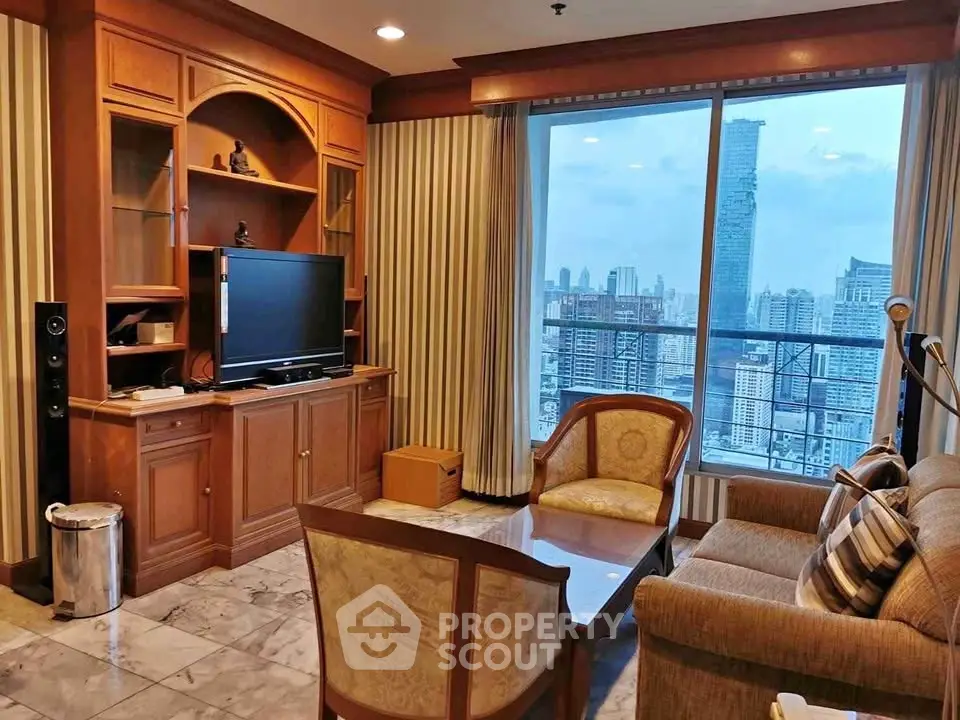 Luxurious living room with stunning city view, elegant furniture, and built-in entertainment center.