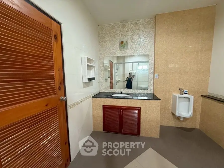 Spacious bathroom with wooden accents and modern fixtures.