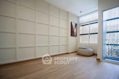 Spacious minimalist room with large window and modern decor