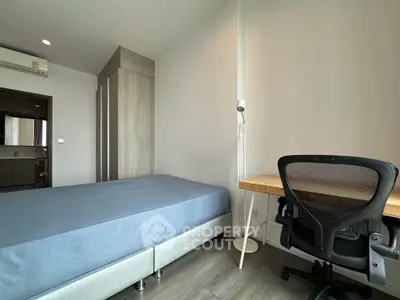 Modern bedroom with study area featuring a sleek desk and ergonomic chair, perfect for work-from-home setup.