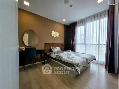 Modern bedroom with stylish decor and large window for natural light