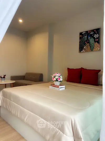 Cozy bedroom with elegant decor and comfortable seating area, perfect for relaxation.