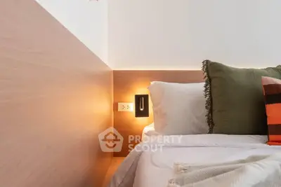Cozy modern bedroom with stylish lighting and plush pillows