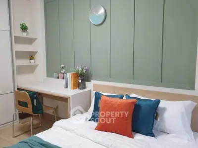Modern bedroom with stylish decor and workspace, featuring a cozy bed and elegant wall paneling.