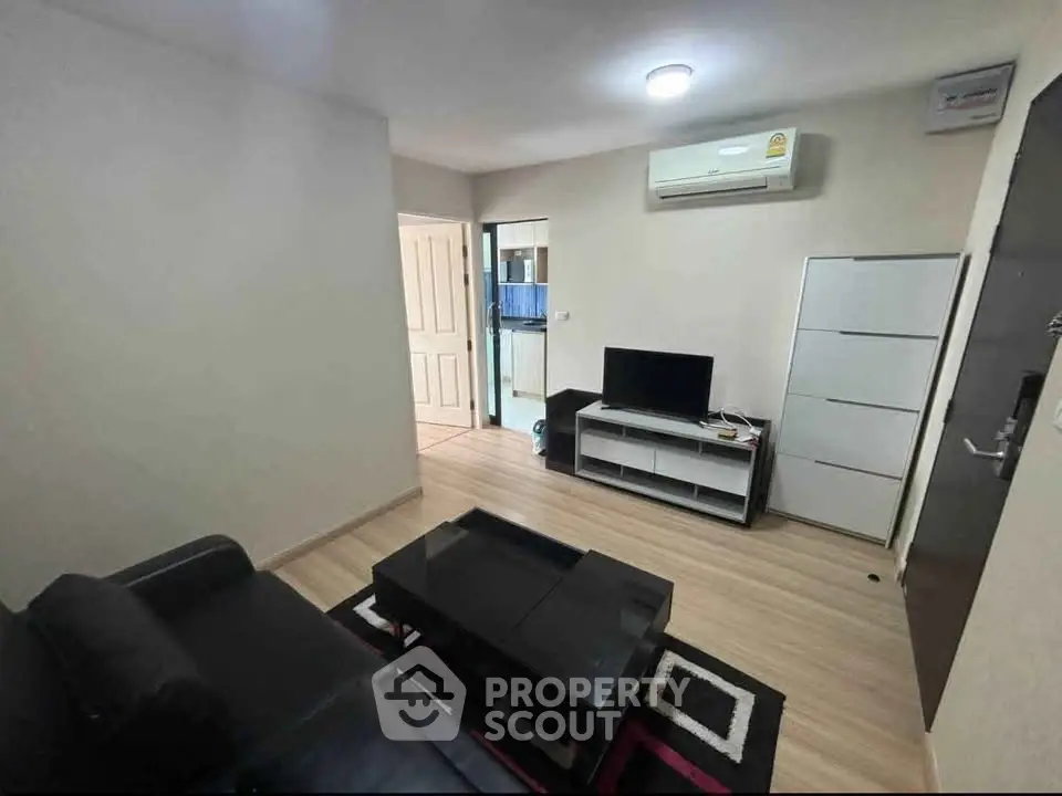 Modern living room with sleek furniture and air conditioning in a cozy apartment.