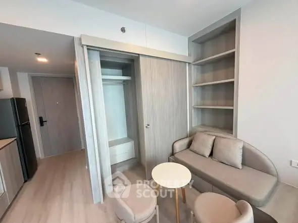 Modern living room with built-in shelves and cozy seating in a stylish apartment.