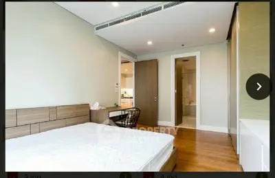 Spacious bedroom with modern design and ensuite bathroom in a luxury apartment.