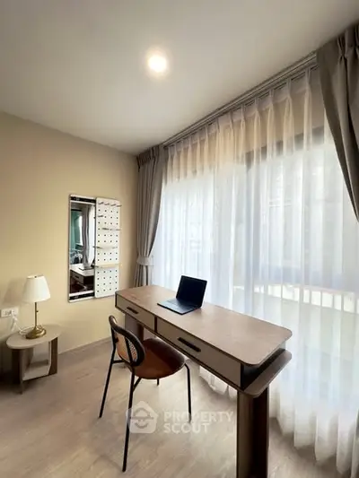 Modern study room with elegant desk and large window curtains