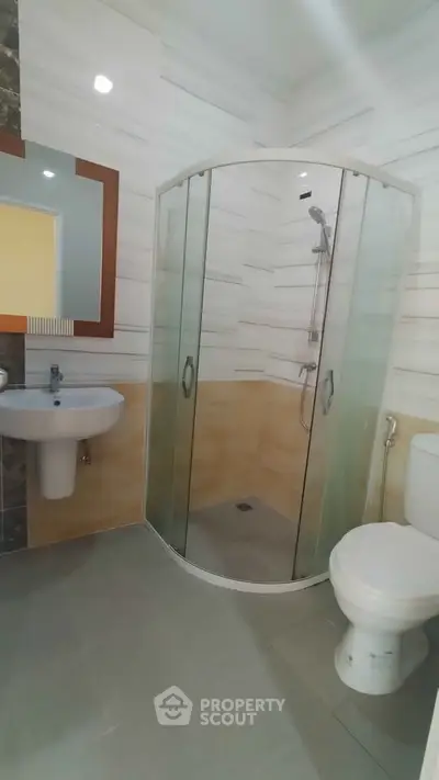 Modern bathroom with glass shower and sleek fixtures