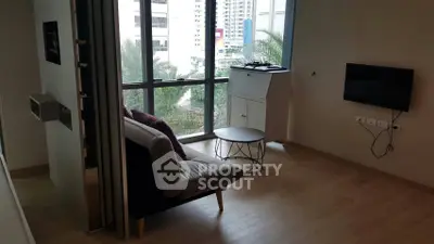 Modern living room with large windows and stylish furniture in urban apartment