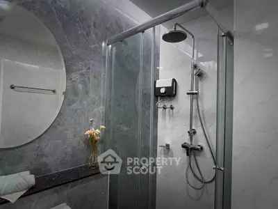 Modern bathroom with sleek shower and elegant marble walls
